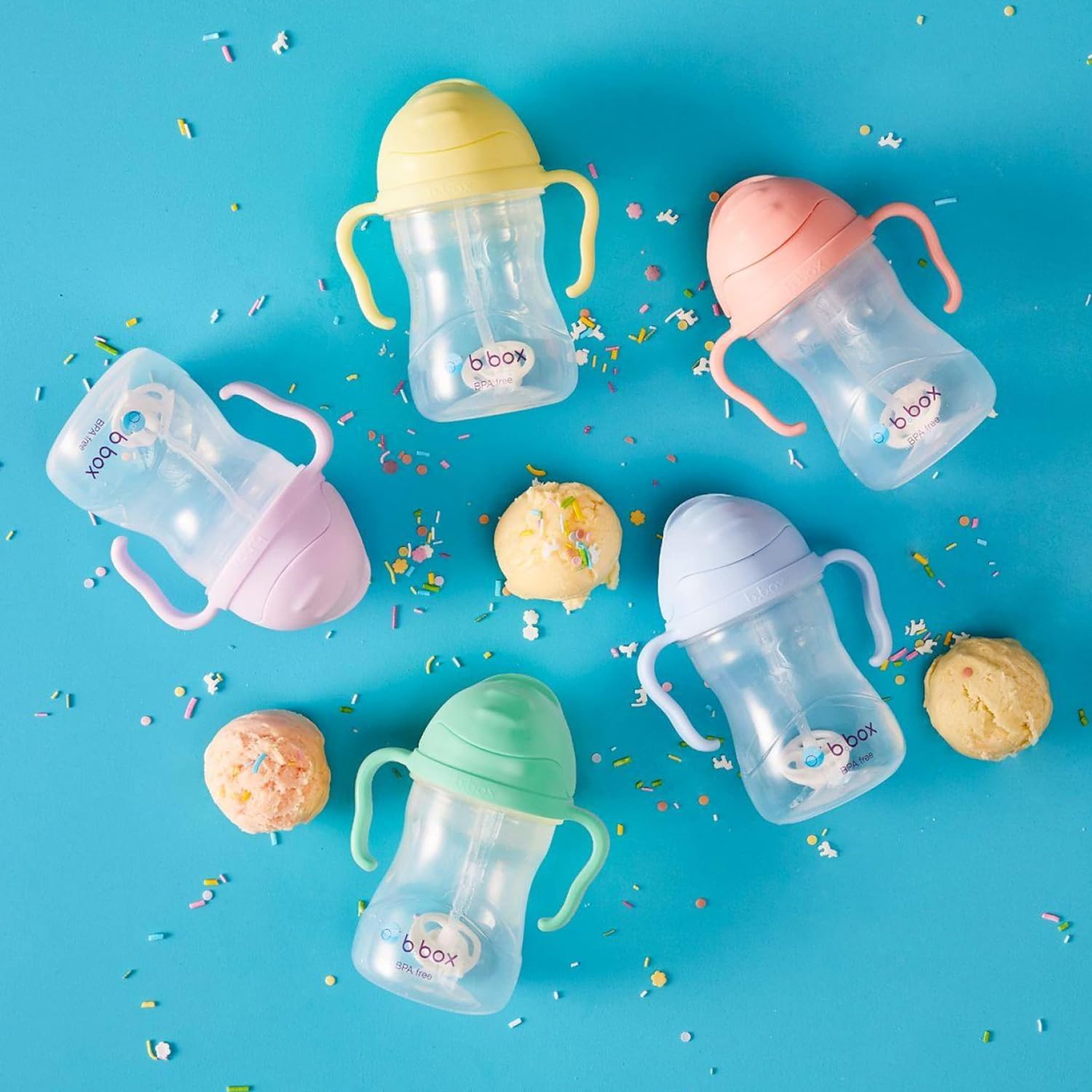 A group of baby bottles with handlesDescription automatically generated